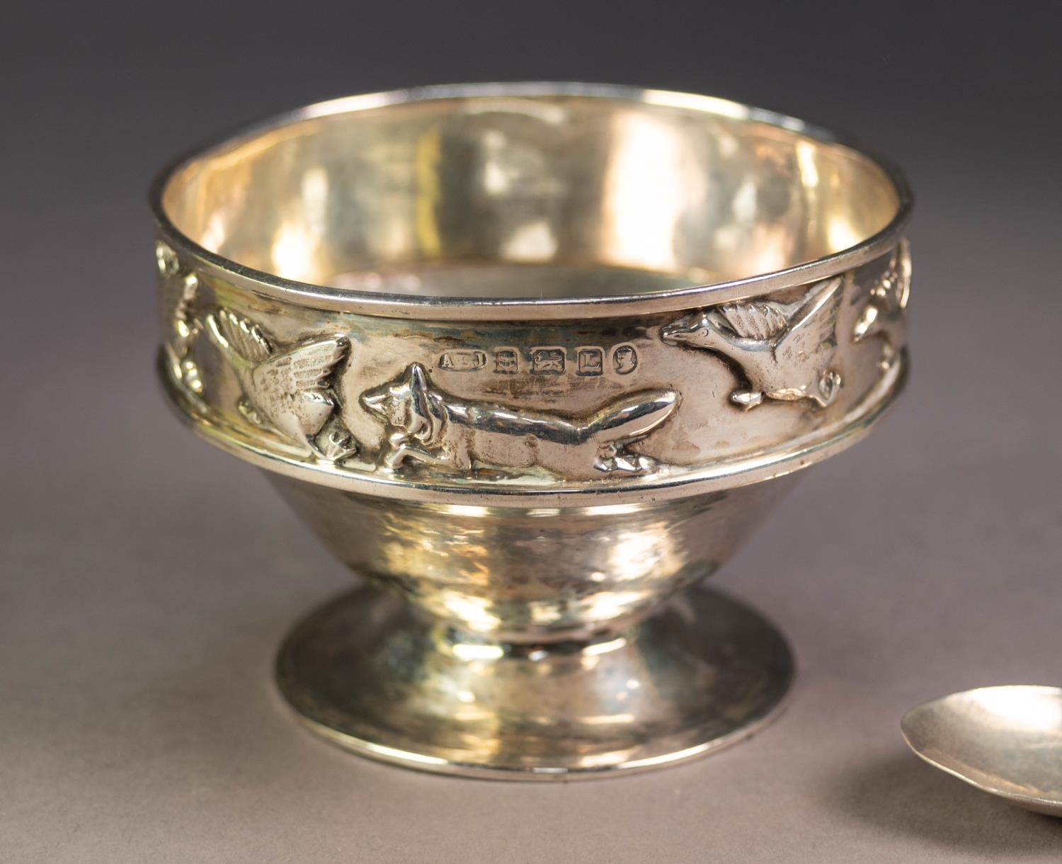GEORGE V ARTS AND CRAFTS EMBOSSED AND PLANISHED SILVER PEDESTAL CHILD?S BOWL AND SPOON BY A.E. - Image 2 of 4