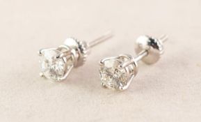 PAIR OF SOLITAIRE DIAMOND STUD EARRINGS each with a round brilliant cut solitaire diamond in a