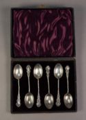 LATE VICTORIAN CASED SET OF SIX SILVER TEASPOONS, with twisted handles and rococo embossed tops,