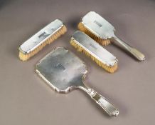 GEORGE VI FOUR PIECE ENGINE TURNED SILVER CLAD DRESSING TABLE HAND MIRROR AND BRUSH SET, comprising: