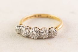 18ct GOLD AND PLATINUM RING CLAW SET WITH FIVE OLD CUT DIAMONDS graduating from the centre, the