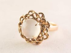 18ct GOLD DRESS RING WITH A CIRCULAR CABOCHON MOONSTONE with asterism, four claw setting with a