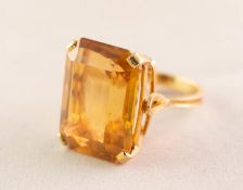 18ct GOLD DRESS RING WITH A LARGE EMERALD CUT CITRINE in a four claw setting, 22mm x 16mm, 12.5 gms,