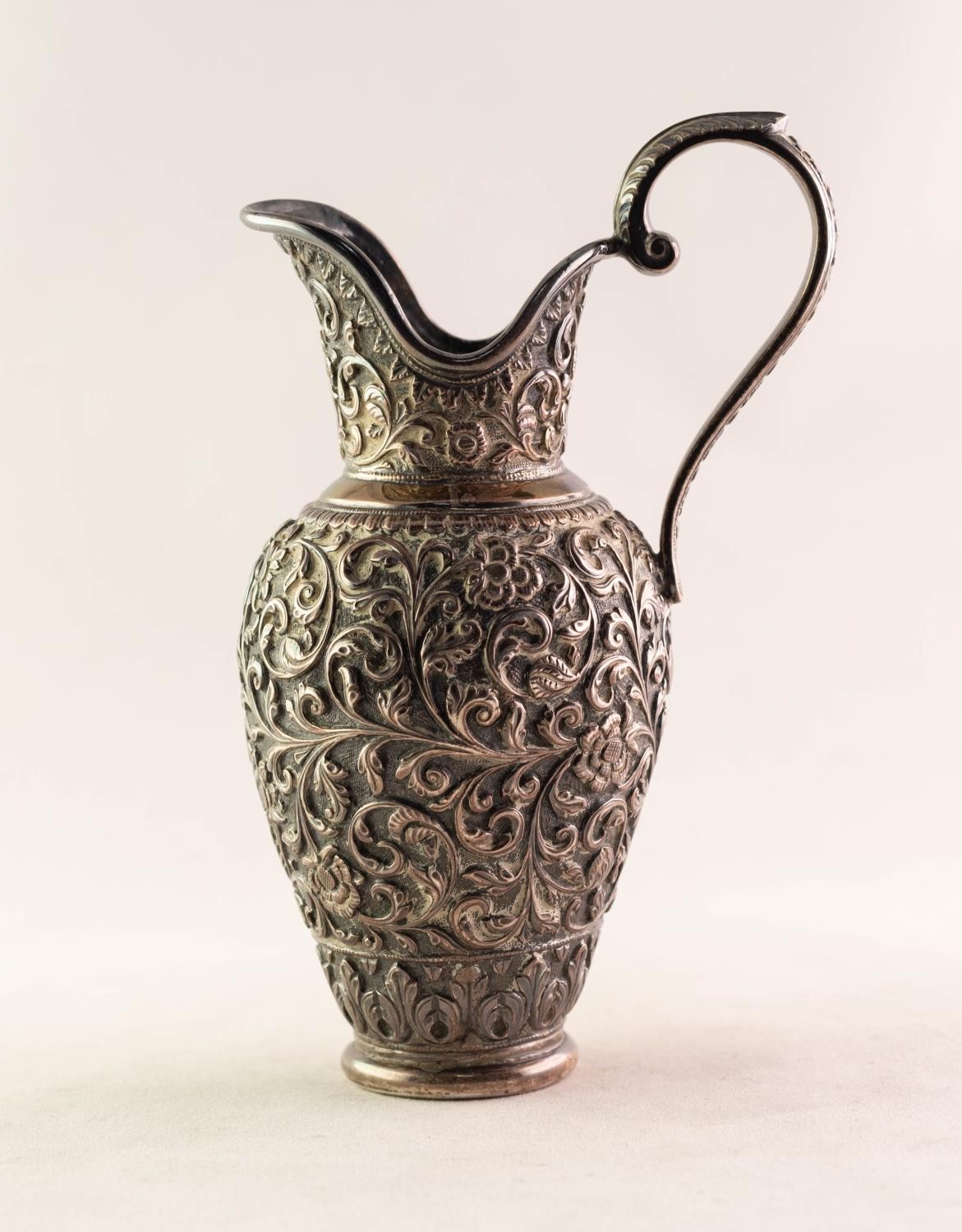 INDIAN SILVER COLOURED METAL URN SHAPED CREAM JUG, with raised C scroll handle with acanthus thumb - Image 2 of 2