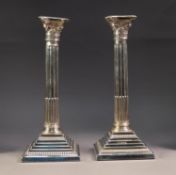 PAIR OF WEIGHTED SILVER CORINTHIAN TABLE CANDLESTICKS, each of part fluted form with removable