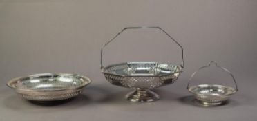TWO ELECTROPLATED SWING HANDLED BASKETS WITH PIERCED BORDERS, the smaller with a MATCHING FOOTED