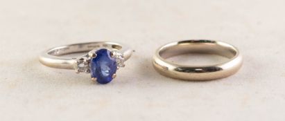 18ct WHITE GOLD, SAPPHIRE AND DIAMOND RING, with raised centre oval blue sapphire in a four claw