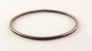 STERLING SILVER BANGLE, channel set with numerous tiny SQUARE CUT AMETHYSTS, the sides engraved with