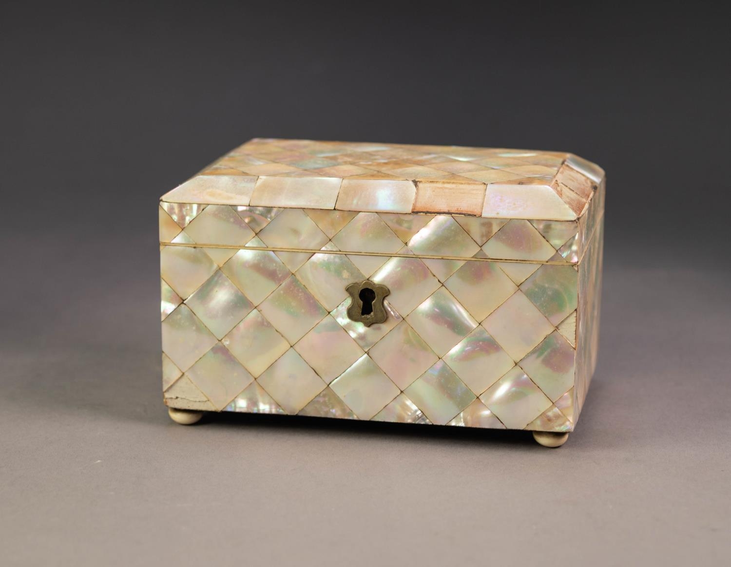 NINETEENTH CENTURY MOTHER OF PEARL CLAD SMALL TEA CADDY, of oblong form with chamfered lid, turned