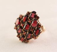 9ct GOLD AND GARNET CLUSTER RING with a marquise shaped setting of nine oval garnets, 6gms, ring