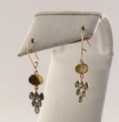 PAIR OF GOLD COLOURED METAL DROP EARRINGS, each set with six small tear shaped blue stones, 1gm