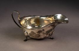 GEORGE V SILVER SAUCE BOAT, with cyma border, high scroll handle and pad feet, 6? (15.2cm) long,