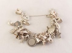 SILVER CURB LINK CHARM BRACELET with padlock clasp and approximately twenty six small SILVER CHARMS,