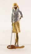 18ct THREE-COLOUR GOLD BROOCH IN THE FORM OF A LADY GOLFER, leaning on her golf club, 2 3/8in (
