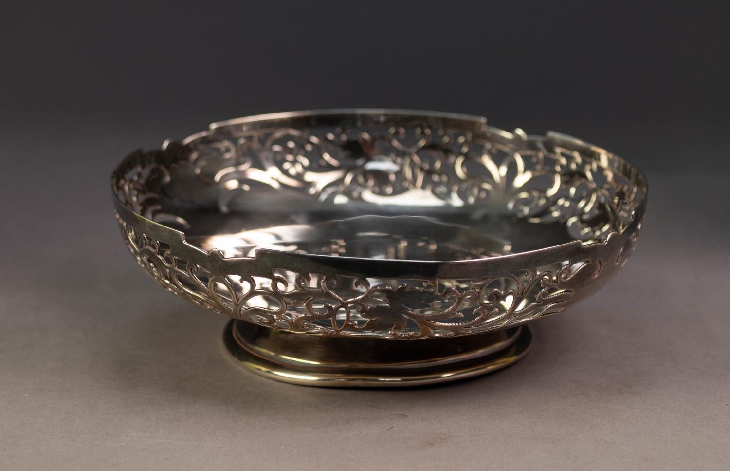 GEORGE VI PIERCED SILVER PEDESTAL SHALLOW DISH, with foliate pierced border and moulded circular