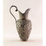 INDIAN SILVER COLOURED METAL URN SHAPED CREAM JUG, with raised C scroll handle with acanthus thumb