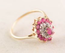 9ct GOLD RUBY AND TINY DIAMOND OVAL THREE-TIER CLUSTER RING, set with a centre marquise shaped ruby,