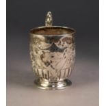 VICTORIAN EMBOSSED SILVER PEDESTAL CHRISTENING MUG, with fancy double C scroll handle and moulded