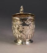 VICTORIAN EMBOSSED SILVER PEDESTAL CHRISTENING MUG, with fancy double C scroll handle and moulded