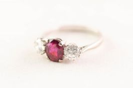 18ct WHITE GOLD RING SET WITH A CENTRE OVAL RUBY, flanked by two round brilliant cut diamonds,