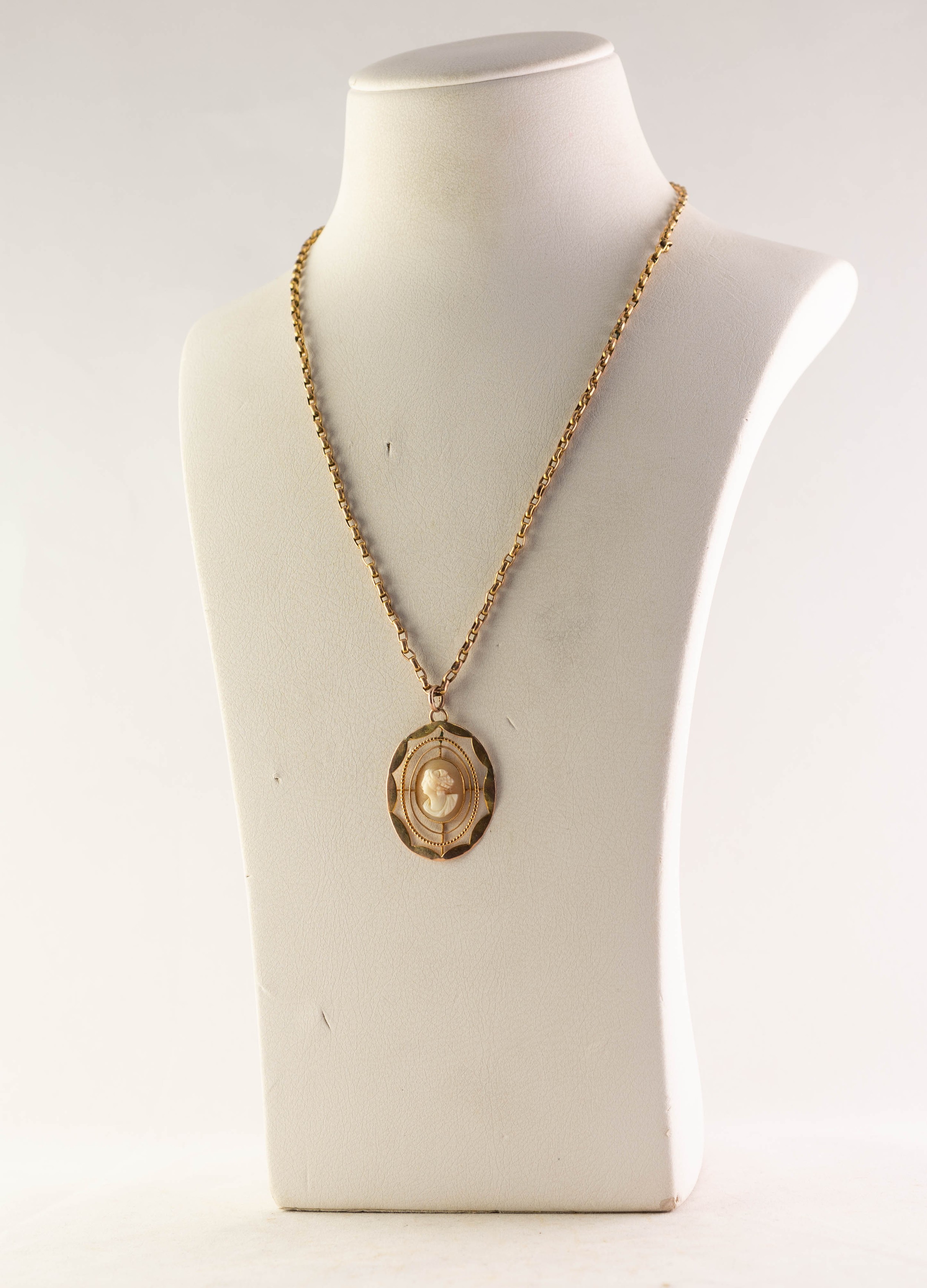 9ct GOLD PENDANT set with a small carved oval shell cameo and the gold coloured metal BELCHER