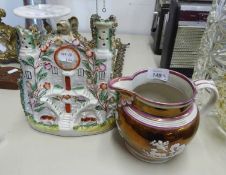 A SUNDERLAND LUSTRE POTTERY JUG AND A STAFFORDSHIRE POTTERY COTTAGE ORNAMENT WITH CLOCK FACE (2)