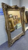 A VERY LARGE RECTANGULAR WALL MIRROR, IN ORNATE SILVERED FINISH ROCOCO SWEPT FRAME, 5'5" HIGH, 4'