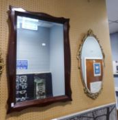 AN OBLONG MAHOGANY FRAMED WALL MIRROR AND AN OVAL GILT FRAMED WALL MIRROR (2)