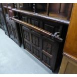 JACOBEAN STYLE STAINED PINE BAR COUNTER WITH NINE FRAMED PANELS TO THE FRONT, WITH HAND RAIL, OPEN