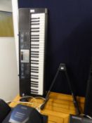 A CASIO LK-170 ELECTRONIC KEYBOARD AND A GUITAR STAND (2)