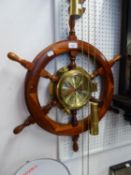 A BRASS CASED CLOCK FITTED INTO A SHIPS STEERING WHEEL