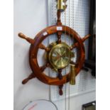 A BRASS CASED CLOCK FITTED INTO A SHIPS STEERING WHEEL