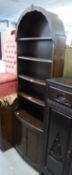 DUTCH STYLE DARK OVAL FIVE TIER ARCH TOPPED OPEN BOOKCASE, ON TWO DOOR CUPBOARD BASE, 1?9? WIDE