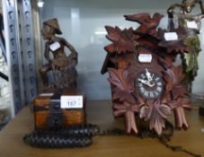 SMALL CUCKOO CLOCK OF TRADITIONAL FORM WITH PAIR OF PINE CONE WEIGHTS, POSSIBLY VIETNAMESE CARVED