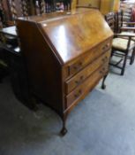 A GOOD QUALITY GEORGE III STYLE FIGURED MAHOGANY BUREAU, WITH THREE LONG DRAWERS, ON FOUR CARVED