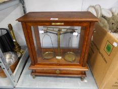 A BRASS CHEMICAL BALANCE SCALES IN MAHOGANY AND GLAZED CASE (ONE GLASS PANEL MISSING)