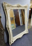 A VERY LARGE RECTANGULAR WALL MIRROR, IN ORNATE WHITE FINISH ROCOCO SWEPT FRAME, 5'5" HIGH AND 4'