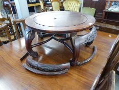 CHINESE PADOUK WOOD CIRCULAR LOW OCCASIONAL TABLE, WITH CARVED AND CURVED APRON, ON FOUR SCROLL