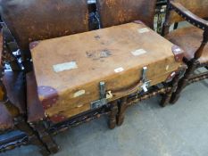 A VINTAGE LEATHER SUITCASE WITH REINFORCED CORNERS