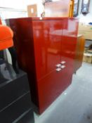 A RED HIGH GLOSS SIDE CABINET, ENCLOSED BY TWO PAIRS OF DOORS, 3' WIDE X 4'1" HIGH