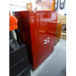 A RED HIGH GLOSS SIDE CABINET, ENCLOSED BY TWO PAIRS OF DOORS, 3' WIDE X 4'1" HIGH