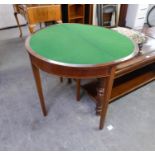 A MAHOGANY INLAID DEMI-LUNE CARD/GAMES TABLE, THE FOLDING TOP REVEALING A GREEN BAIZE, RAISED ON