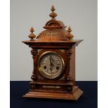 EARLY TWENTIETH CENTURY CARVED WALNUT MANTLE CLOCK, the 4? Roman dial with scrolled centre,