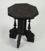 MIDDLE EASTERN CARVED AND EBONISED OCCASIONAL TABLE, the octagonal top set above an X shaped base