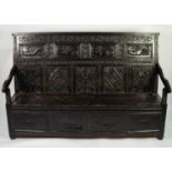 SEVENTEENTH CENTURY CARVED DARK OAK LARGE BOX SETTLE, the sloping back with four panels carved