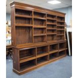 A LATE VICTORIAN LARGE MEDIUM OAK OPEN LIBRARY BOOKCASE, with egg and dart carved and moulded
