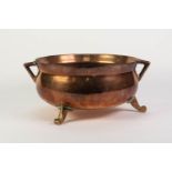 HEAVY COPPER TWO HANDLED CAULDRON PATTERN SHALLOW JARDINIÈRE, with brass scroll feet, 6? (15.1cm)