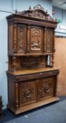 LATE NINETEENTH/ EARLY TWENTIETH CENTURY CONTINENTAL CARVED WALNUT HUNTER?S CABINET, the moulded