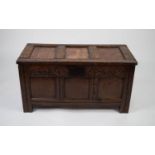 SEVENTEENTH CENTURY CARVED OAK COFFER, the triple panelled top above a conforming front with heavy