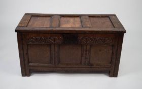 SEVENTEENTH CENTURY CARVED OAK COFFER, the triple panelled top above a conforming front with heavy